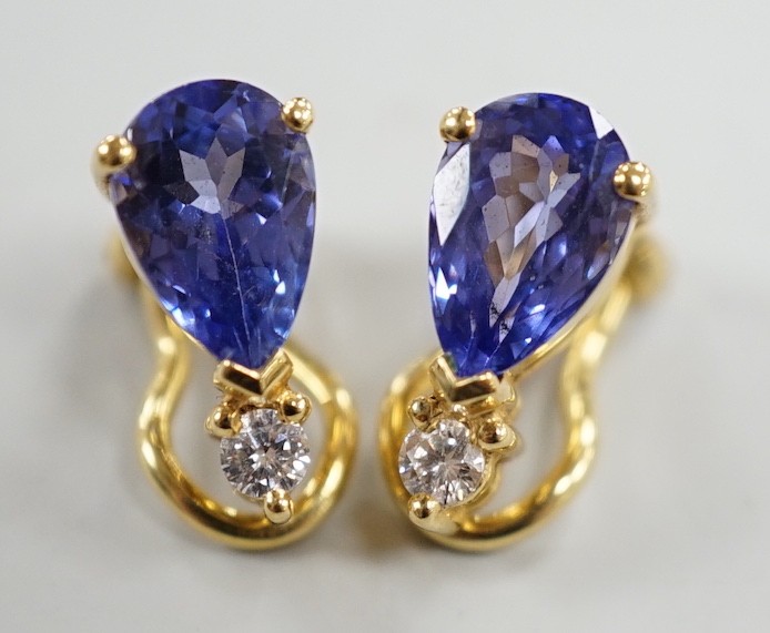 A modern pair of 18k, tanzanite and diamond set ear clips, 13mm, gross weight 4.4 grams.